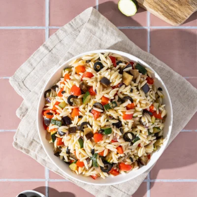 Mediterraner Nudelsalat mit Oliven in weißer schale