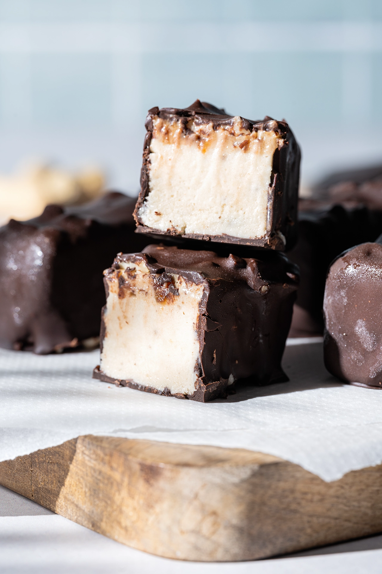 Vegane Eisriegel im Snickers-Style - ohne Zucker 2 Vegane Eisriegel im Snickers-Style ohne Zucker aufgeschnitten auf Brett