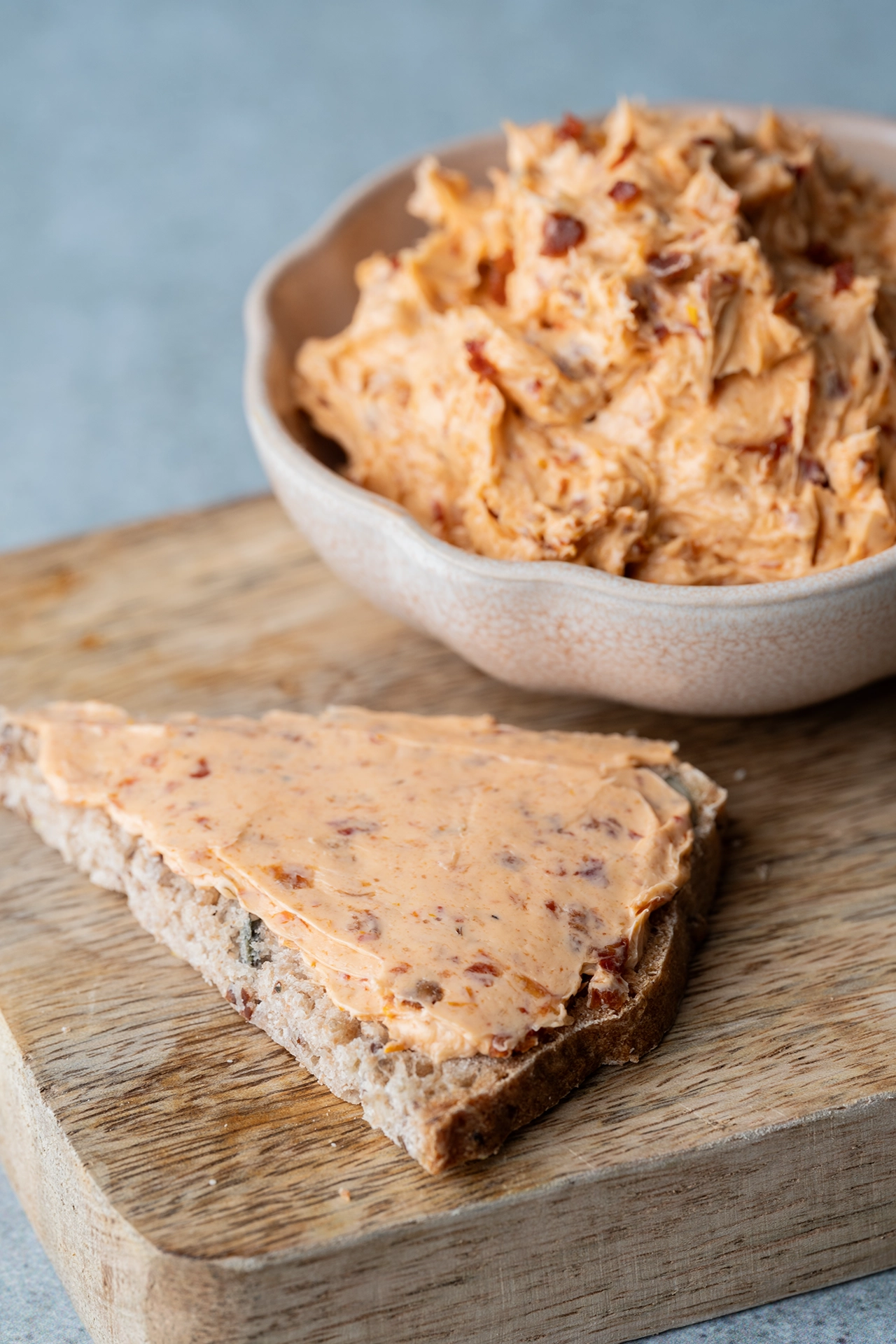 Vegane Tomaten-Butter 1 Tomatenbutter auf einem Stück Brot auf einem Brett