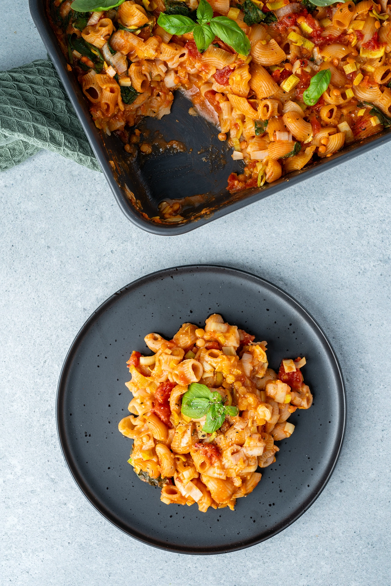 Nudelauflauf ohne Vorkochen 2 Nudelauflauf auf einem dunklen Teller und eine dunkle Auflaufform mit dem Rest Auflauf